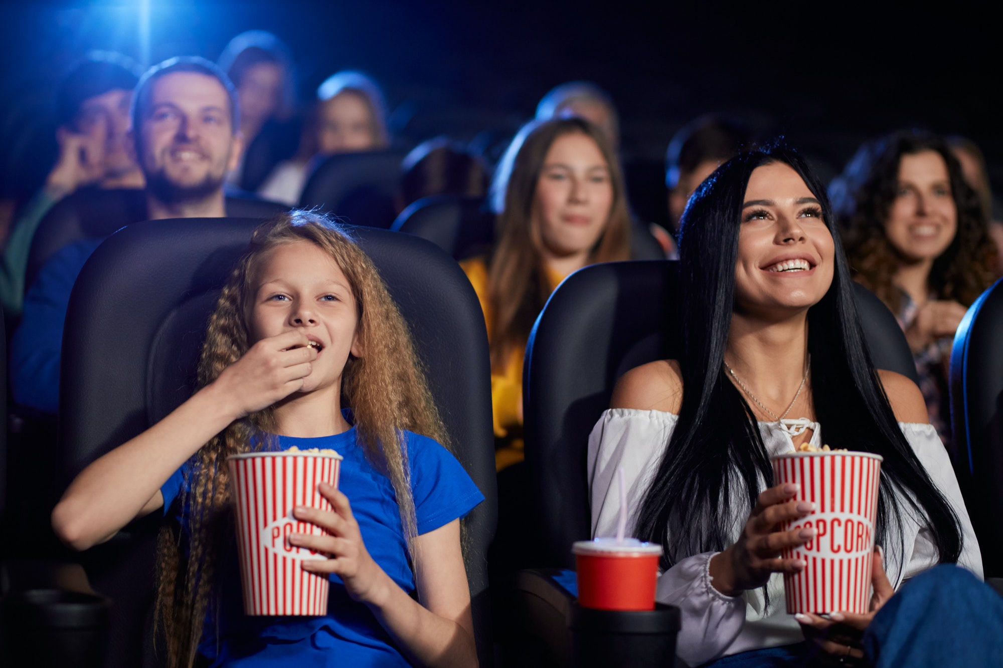 young-woman-with-younger-sister-in-cinema.jpg